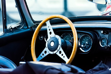 Close Up View of Old Car Steering Wheel and Dashboard