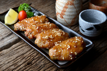 Fried chicken wing with spicy sauce in Japanese tebasaki style.