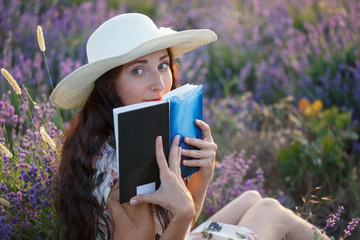 Romantic woman with book on lavender field