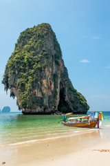 Scenics View of Long Tail Boat on Phra Nang Beach Against Rock Island