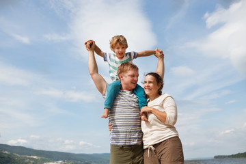happy family mother, father and little son Having Fun outdoors in summer