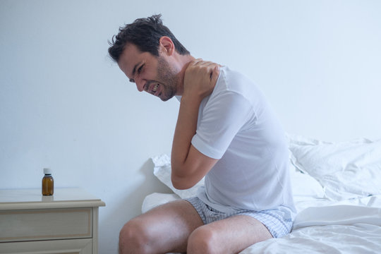 Man Feeling Stiff Neck In The Bed After Sleeping