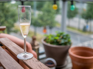 Glass of champagne on balcony.