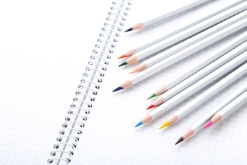 Drawing colourful pencils with blank notebook