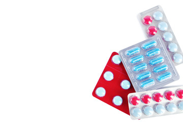 Different pills in blister pack on white background
