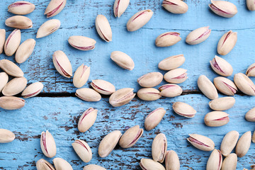 Pistachios on blue wooden table