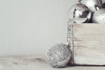 silver Christmas balls in a wooden vintage box. copy space.