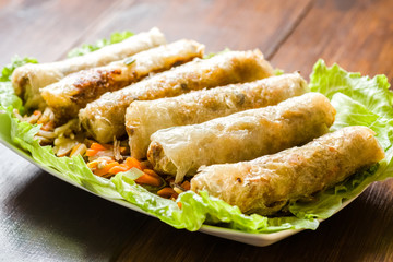 Spring rolls surrounded by vegetables