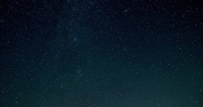 Timelapse video of night sky with falling stars turning into white for transition