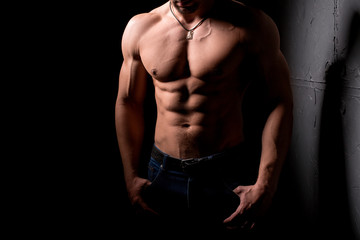 Fototapeta na wymiar Fitness concept. Muscular and sexy torso of young man having perfect abs, bicep and chest. Male hunk with athletic body.