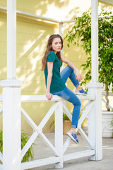 Young beautiful brown haired woman in blue jeans