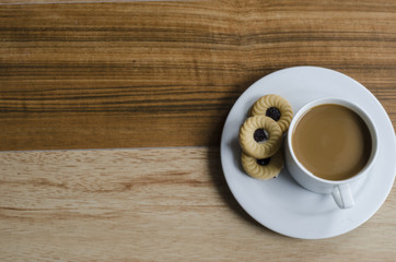 coffee and cookie on wooden table