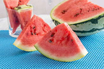 Juicy pieces of watermelon on a blue napkin.