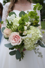 Bride Holding a Pink, White and Green Wedding Bouquet