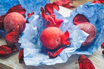 Red ripe plums on a wooden background closeup