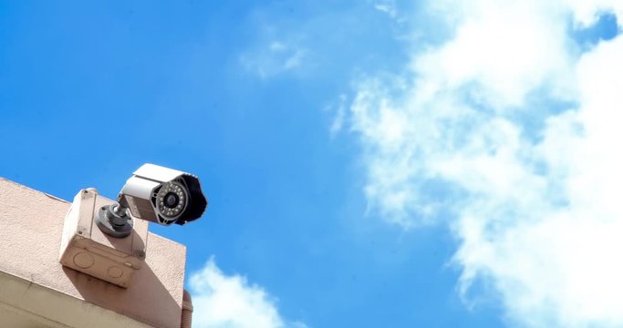 Time Lapse Moving White Cloud In Summer Blue Sky And Outdoor Security Camera Making Urban Life More Safety - 4K.