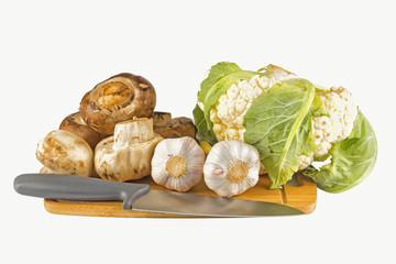 Mushrooms and vegetables on white isolated background