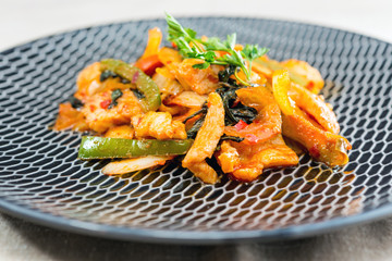 wok fried chicken stir fry with sweet peppers and chinese vegetables