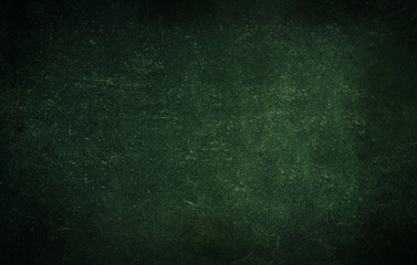 Dark green background of school blackboard colored vignetted texture. Dark green black shabby...