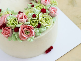 Birthday cake with flowers rose on light background