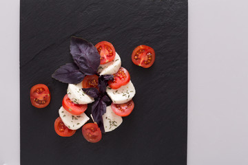Homemade mozzarella on black stone background