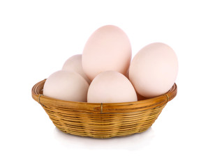 fresh raw duck eggs in bamboo basket and on white background