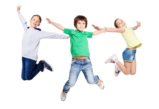 Group of children jumping at white isolated studio background