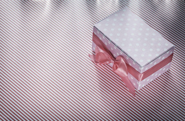 Gift box on red striped tablecloth celebrations concept