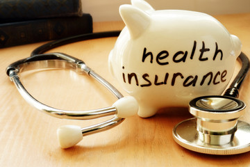 Piggy bank with words on a side health insurance.