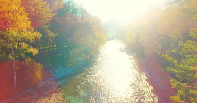 Aerial UHD 4K view. Mid-air flight over fresh mountain river at sunny summer morning. Vertical to horizontal tilt movement.