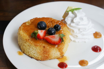 Dessert - cake with syrup, strawberry, blueberry