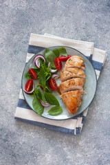 Baked chicken breast and fresh basil and tomatoes salad