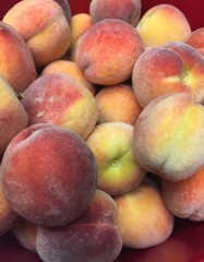 Closeup of organic peaches in bowl