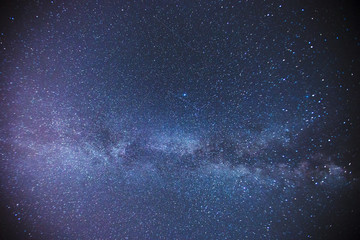 The starry sky above the barn at the farm at night