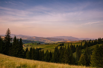 Obraz na płótnie Canvas Background with Ukrainian Carpathian Mountains during the sunset in the Pylypets
