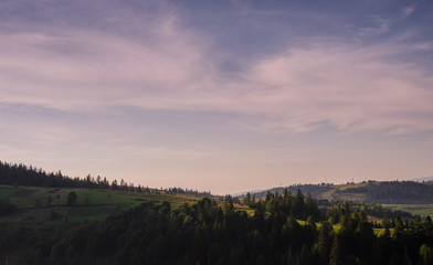 Obraz na płótnie Canvas Background with Ukrainian Carpathian Mountains during the sunset in the Pylypets