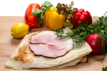 Pork loin on pita bread and vegetables