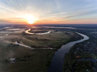 Aerial view of the dawn over the river in the fog