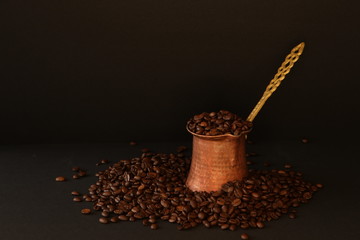 Coffee beans and coffee pot on the dark background