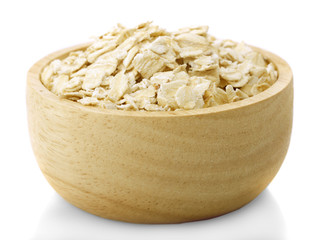 Oat flakes in bowl and wooden isolated on white background