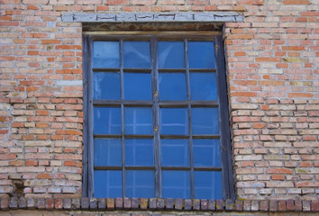 Old wooden window on brick wall.