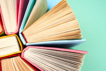 Top view of bright colorful hardback books in a circle.