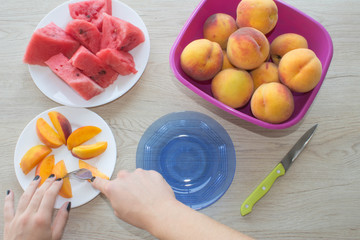 Peaches and slices of watermelon on wood table. fruit on the table