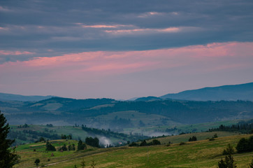Naklejka na ściany i meble Background with Ukrainian Carpathian Mountains during the sunset in the Pylypets