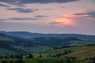 Background with Ukrainian Carpathian Mountains during the sunset in the Pylypets