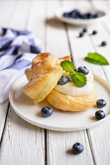 Cream puffs filled with vanilla cream and blueberries