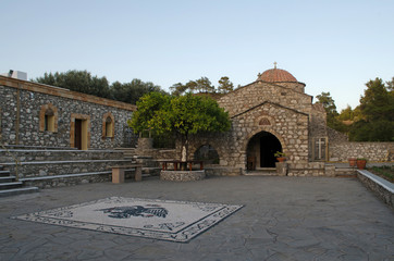 Traditional greek church made from stone, with red roof