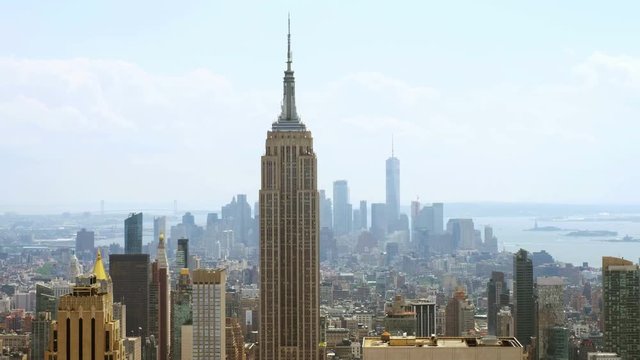 Aerial view on the city skyline in New York City, USA, on a warm sunny summer day with beautiful cloudy sky. A rotating video picturing concrete jungle, including the Empire State Building, Upper Bay.