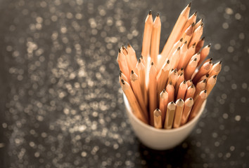 the stack of pencils in a glass