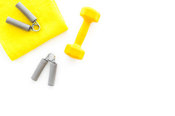 Equipment for fitness. Dumbbells and expander on white background top view copyspace
